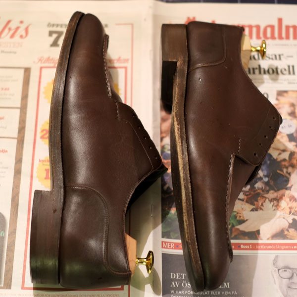 Applying leather conditioner on shoes